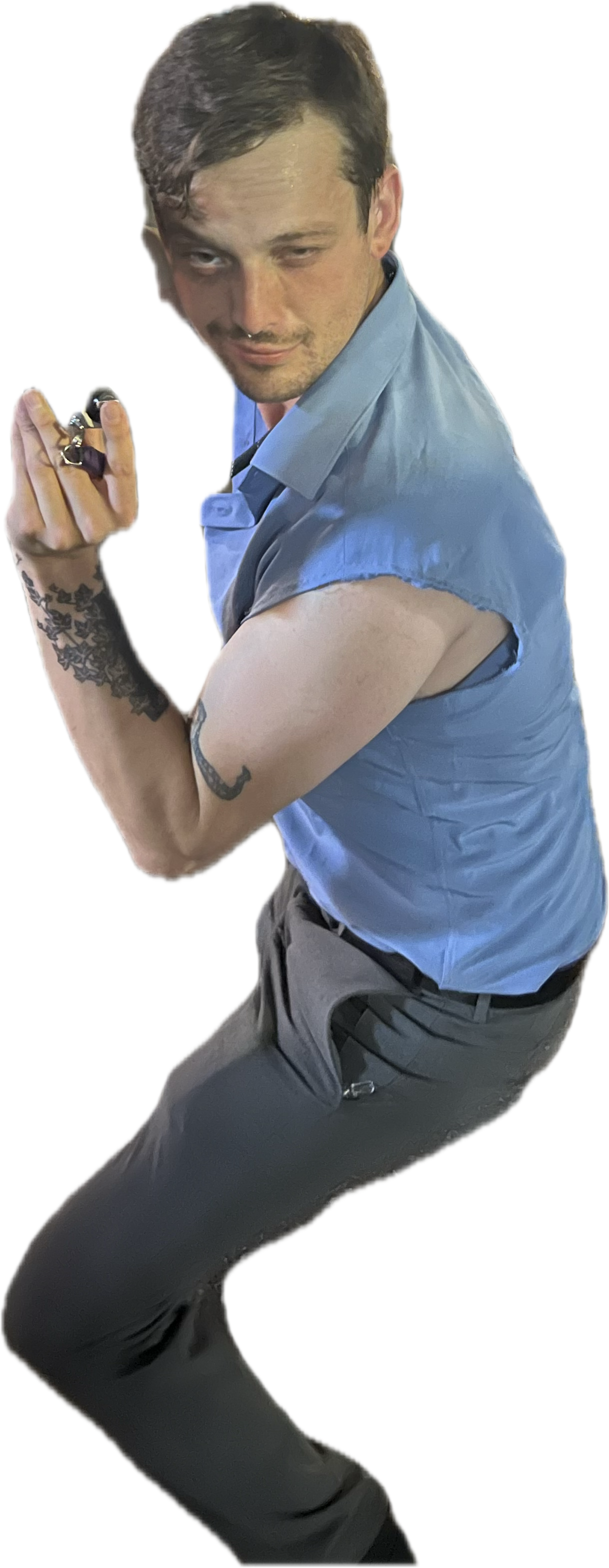A man in a blue shirt striking a pose.